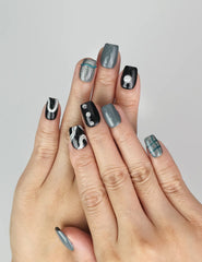 Model wearing Naillover Mystic Swirl handmade Singapore press on nails with black, grey, and marble white design.