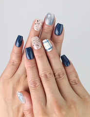 Model wearing Nautical Stripe press on nails by Naillover, showing bold blue and white stripes with a nautical flair.