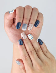 Close-up of Nautical Stripe nails on hand, featuring crisp lines and classic navy-white contrast.