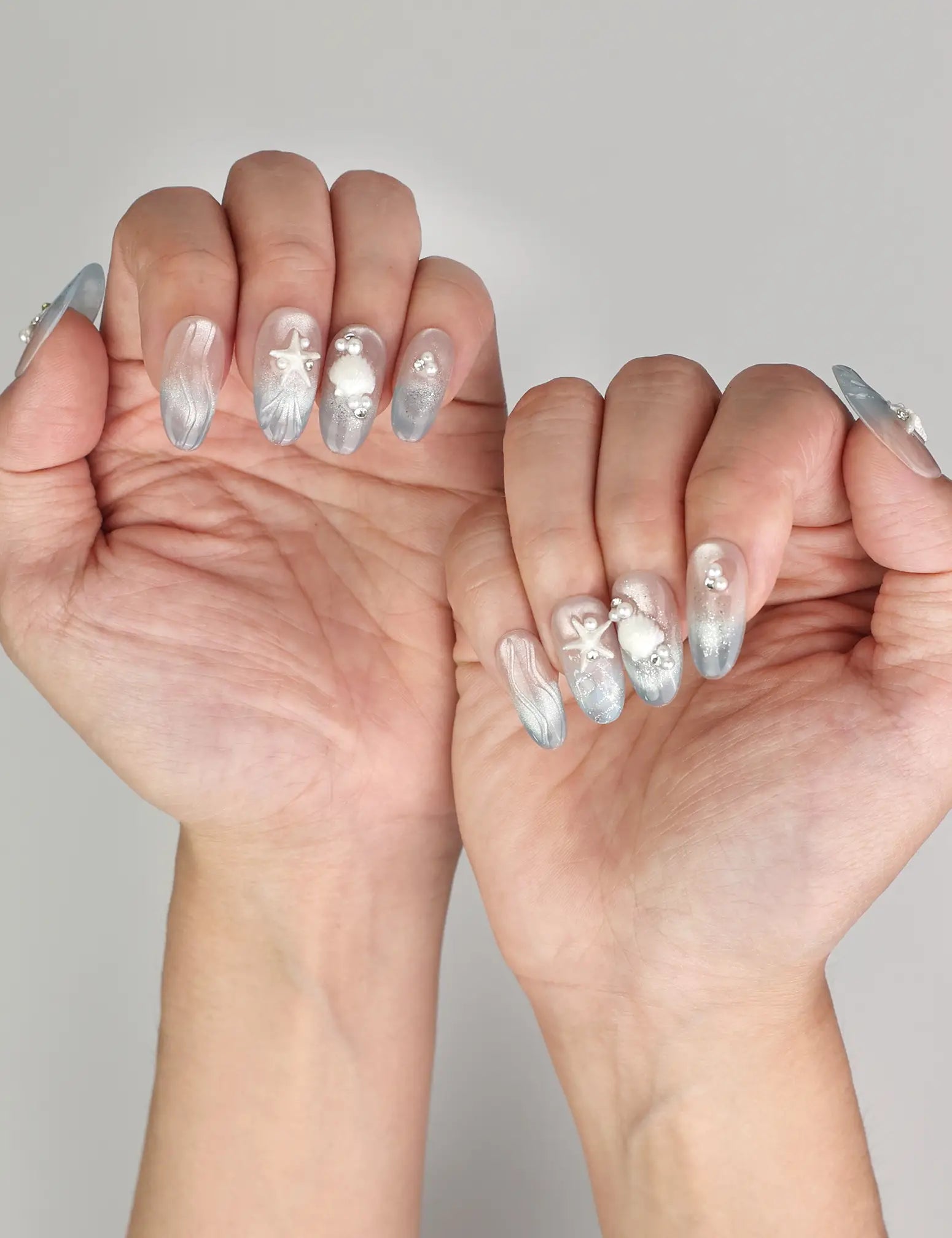 Naillover Ocean Whisper Singapore press on nails styled on hand, showing 3D summer nails with ocean-inspired charm