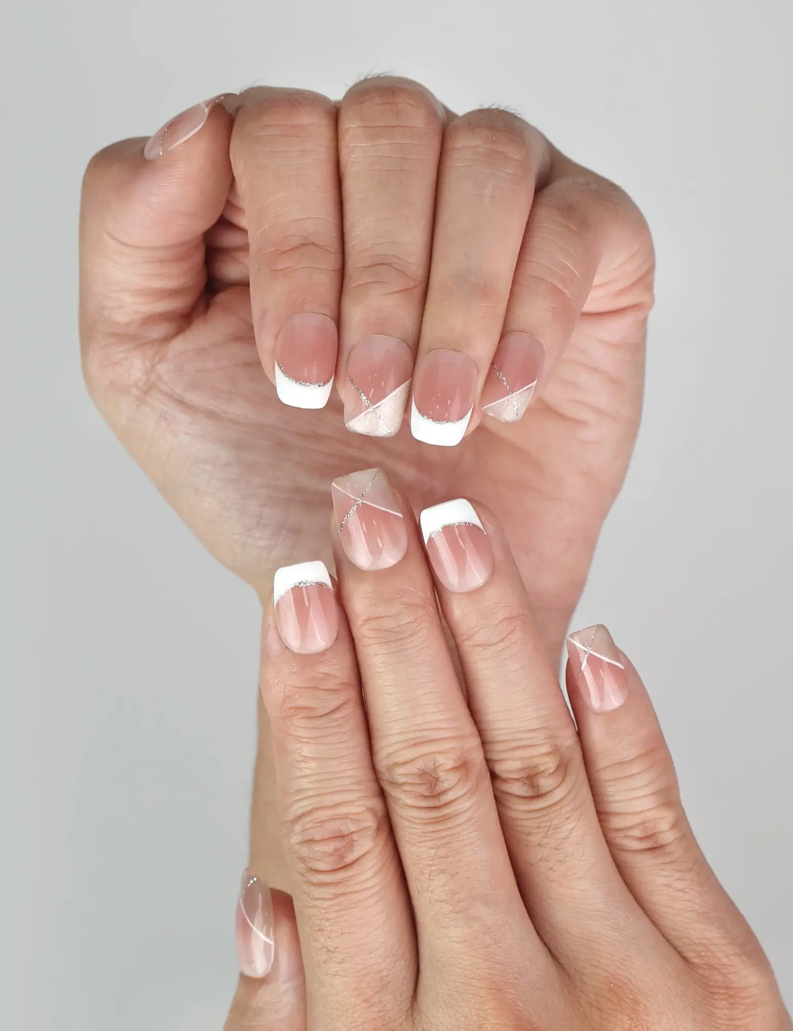 Close-up of Naillover Opal Scheme Singapore press on nails showing silver detailing on pink and white nails.