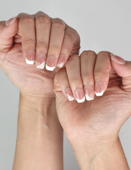 Naillover Opal Scheme classic handmade press on nails in pink and white tones with elegant silver accents on model’s hand.