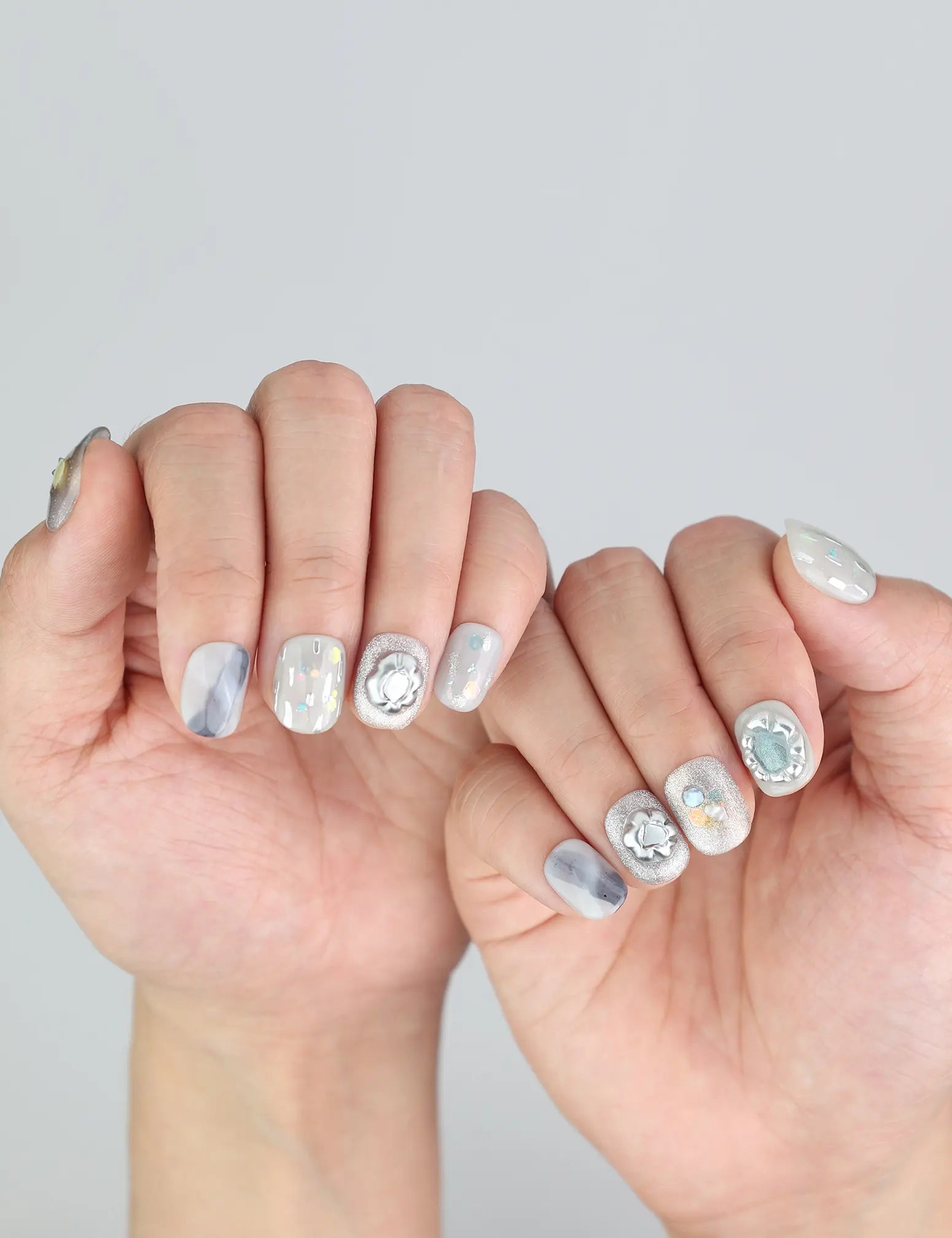 Close-up of Naillover’s trendy short Singapore press on nails in Opal Whisper design.