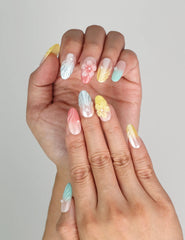 Hand close-up wearing Naillover Pearl Bloom Fantasy handmade press on nails with 3D flowers and pearls.