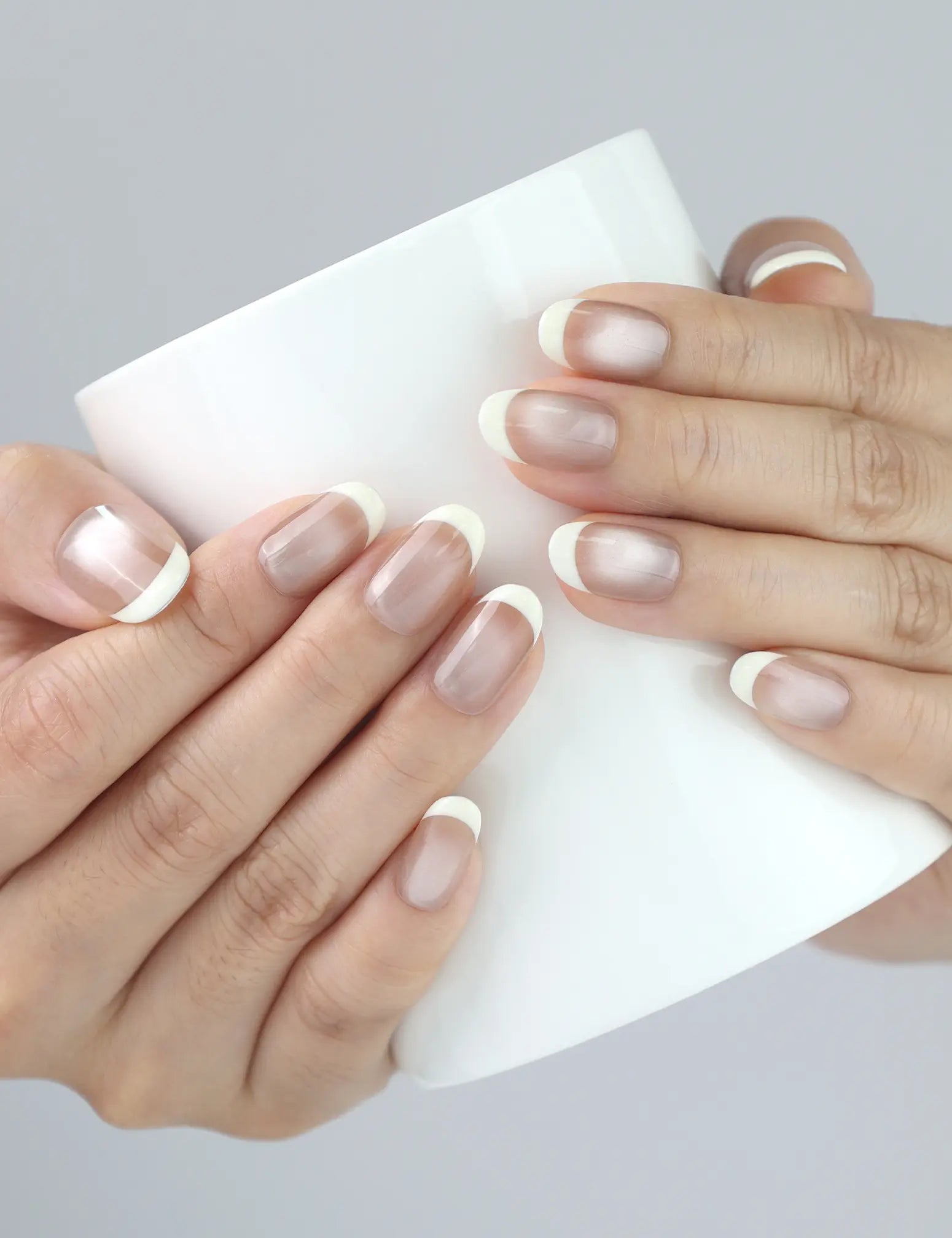 Wearing Pearl Glow nails while holding a coffee cup — natural pearlescent style by Naillover, Singapore handmade press ons.