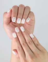 Side view of fingers with Pearl Haze Singapore press on nails showing raised floral detail and natural glossy finish.