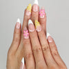 Model wearing Naillover Petal Dream handmade press on nails Singapore with gradient pink and 3D floral accents.