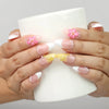 Model holding a cup while wearing Naillover Petal Dream handmade press on nails Singapore with 3D flower details.