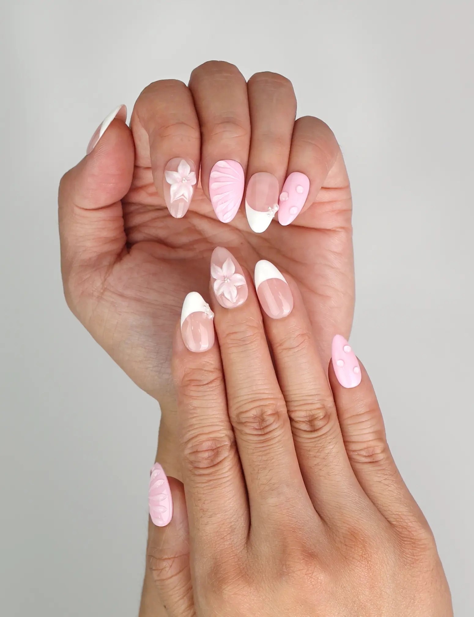 Close-up of Naillover Petal Grace trendy nails showing gradient pink tones and white tips.