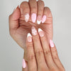 Close-up of Naillover Petal Grace trendy nails showing gradient pink tones and white tips.