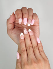 Close-up of Naillover Petal Grace trendy nails showing gradient pink tones and white tips.