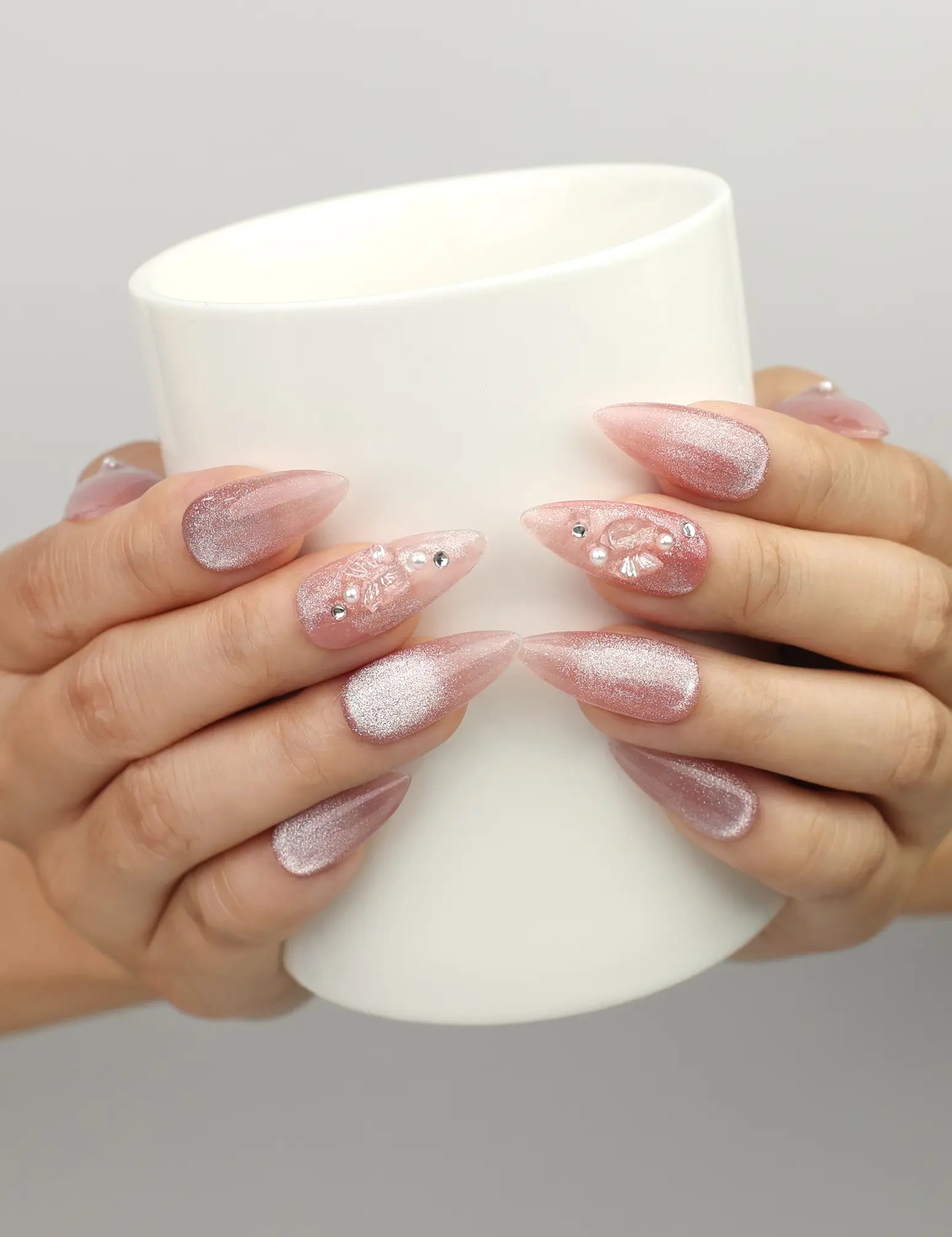 Naillover Pink Brown Star Diamond Butterfly Dream press on nails SG shown while holding a cup, featuring holographic shine with pearls and flowers