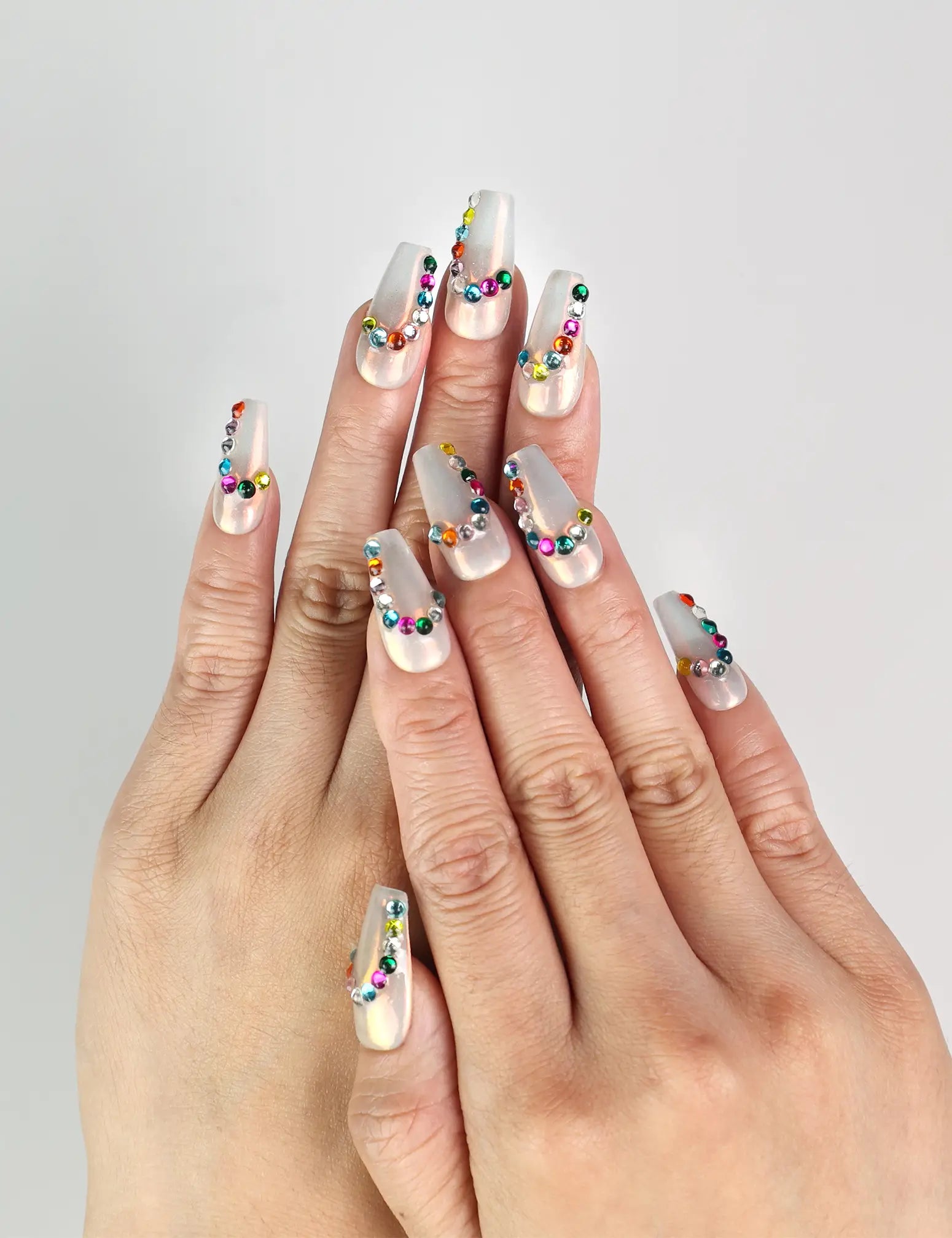 Model wearing Rainbow Arc handmade Singapore press on nails in playful rainbow colors for a cute, trendy look
