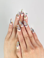 Model wearing Rainbow Arc handmade Singapore press on nails in playful rainbow colors for a cute, trendy look