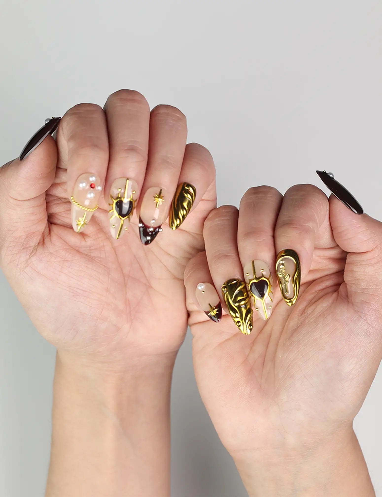 Hand pose with Regal Radiance handmade Singapore press on nails featuring luxurious gold and pearl details