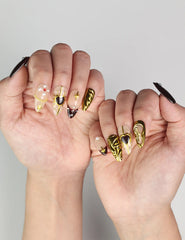 Hand pose with Regal Radiance handmade Singapore press on nails featuring luxurious gold and pearl details