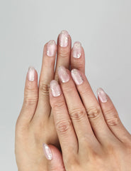 Model wearing Naillover Rosy Engravings handmade Singapore press on nails with golden floral patterns.