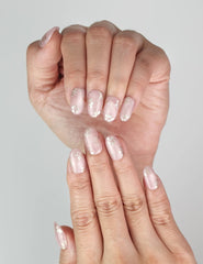 Close-up of Naillover Rosy Engravings trendy handmade press on nails in pink with gold details.