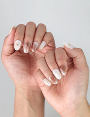 Close-up of fingers styled with Sandy Shine press on nails, combining minimalism and shimmer for a trendy, sun-kissed finish.