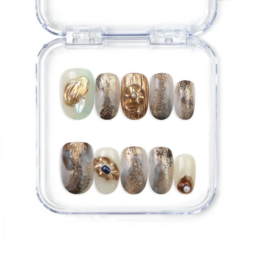 Naillover handmade press on nails in creamy white with gold leaf and pearl accents from the Singapore press on nails collection.