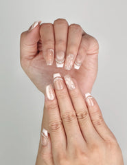 Close-up of Naillover Serene Loops Singapore press on nails showing pearl details and subtle dots.