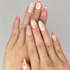 Model wearing Naillover Sweet Pink Yellow 3D Floral Droplet Singapore press on nails with playful pink-yellow blossoms
