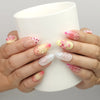 Naillover Sweet Pink Yellow 3D Floral Droplet press on nails SG shown while holding a cup, with floral and dotted embellishments