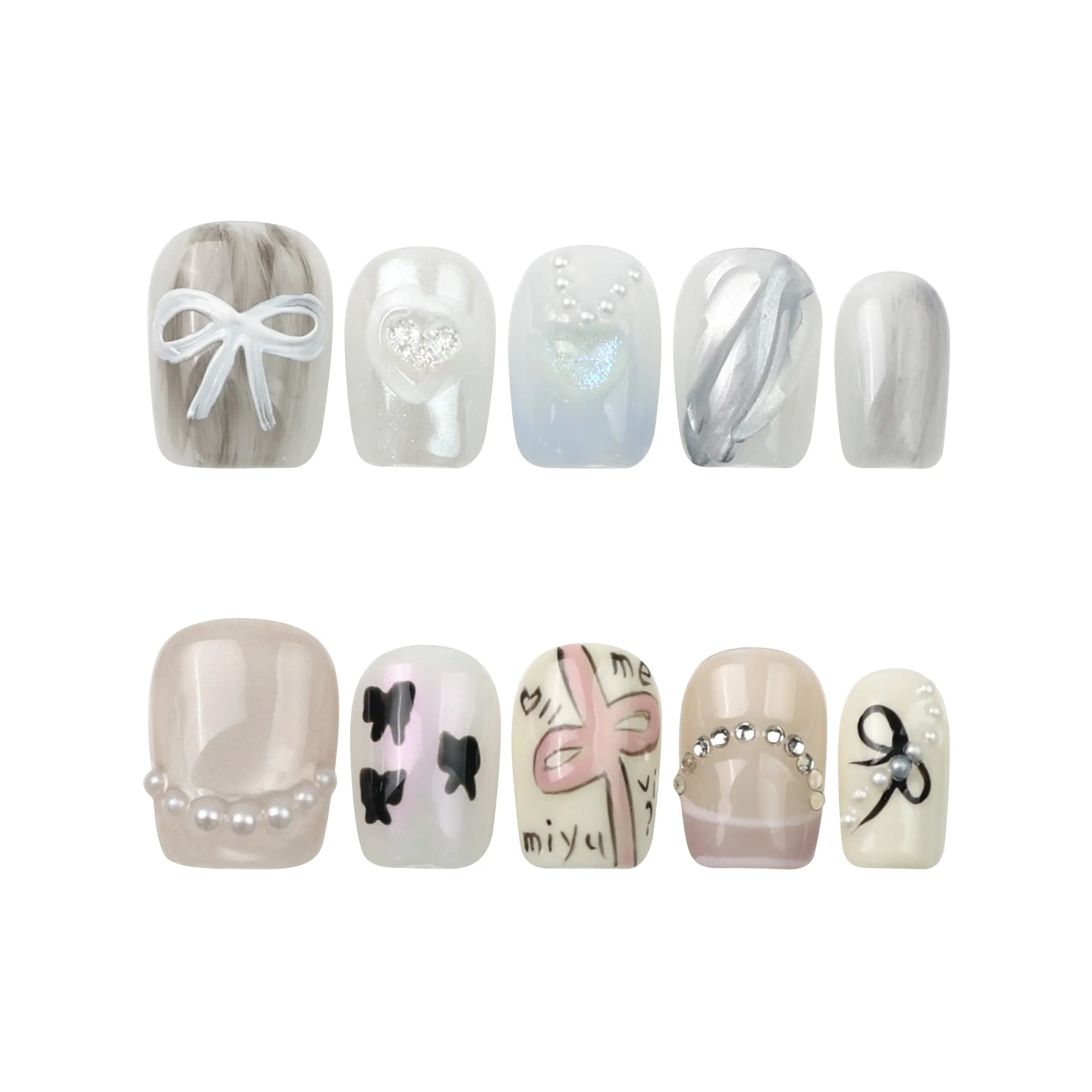 Flat lay of Sweet Ribbon short nails by Naillover—frosted lavender tips on sheer white base with hand-placed crystals.