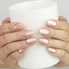 Hand holding a cup with Naillover Tender Shine Singapore press on nails and pearlescent shimmer