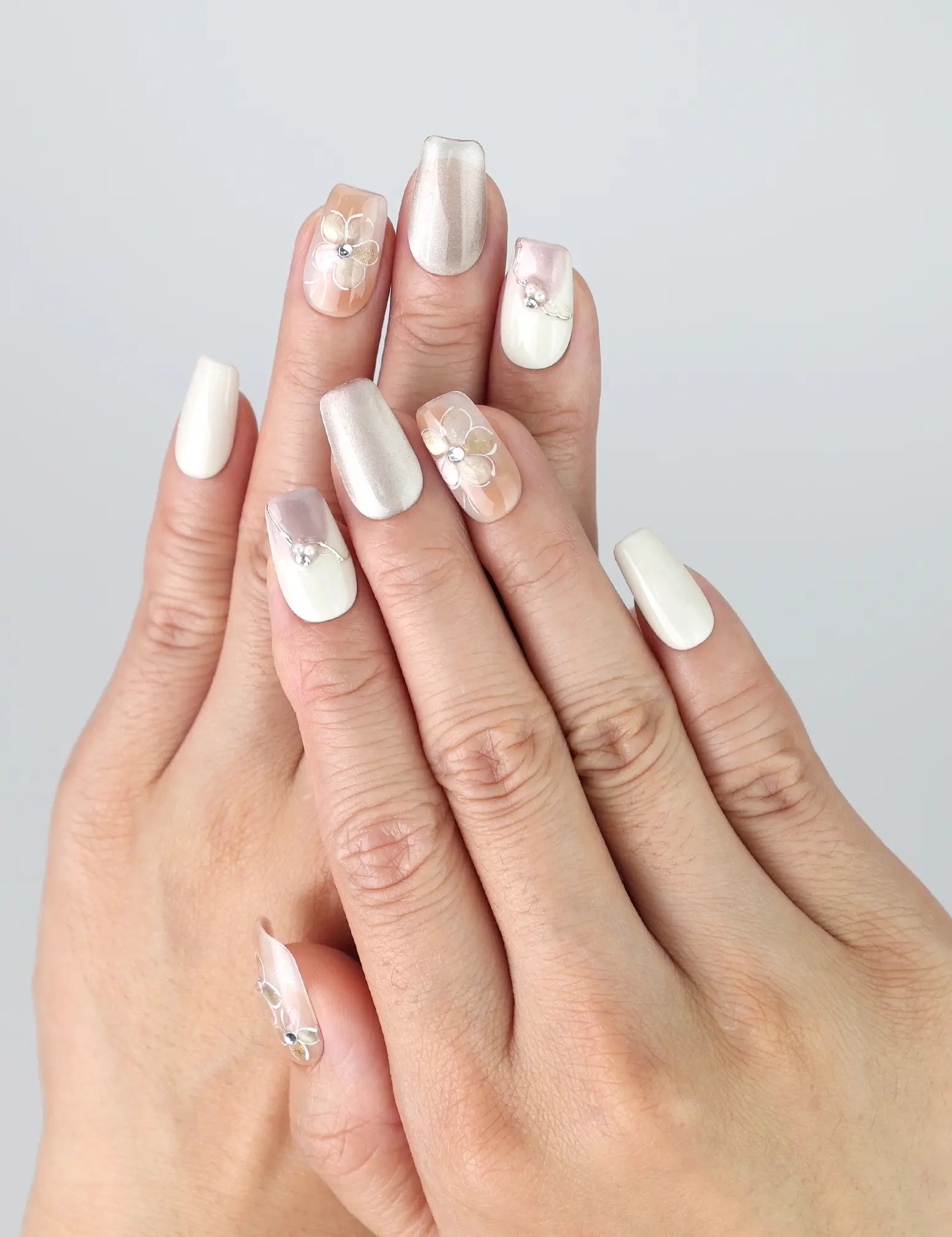 Hand wearing Twilight Singapore press on nails by Naillover, featuring soft pastel tones and raised 3D floral detailing for an elegant evening look.