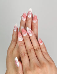 Model wearing Naillover Whisper of Wisteria handmade press on nails Singapore with blush pink gradient and 3D floral accents.