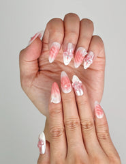 Close-up of Naillover Whisper of Wisteria 3D floral nails, showing butterfly and flower details on blush gradient base.