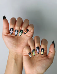 Artistic almond press-ons with hand-drawn iris blooms over a dark base, showcasing Naillover’s floral craftsmanship