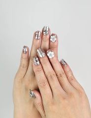 Hand wearing Nightfall handmade Singapore press on nails in metallic silver with rhinestones, evening-ready style by naillover.
