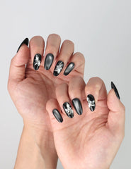 Side view of elegant oval nails with a night-sky aesthetic, silver gradient accents, and sparkling butterfly embellishments