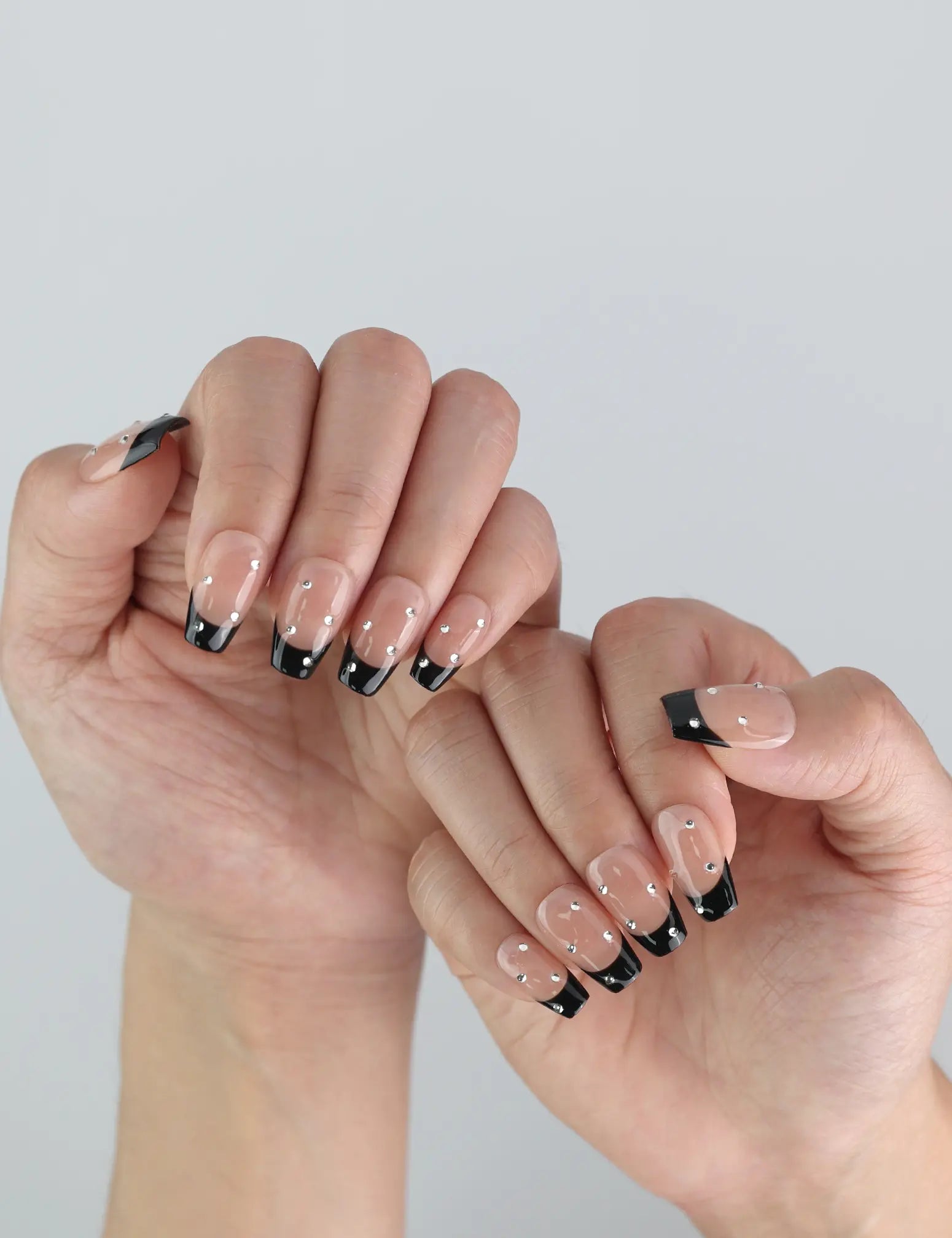 Naillover Nude Edge handmade press on nails styled on hand, highlighting bold black tips and elegant shine.