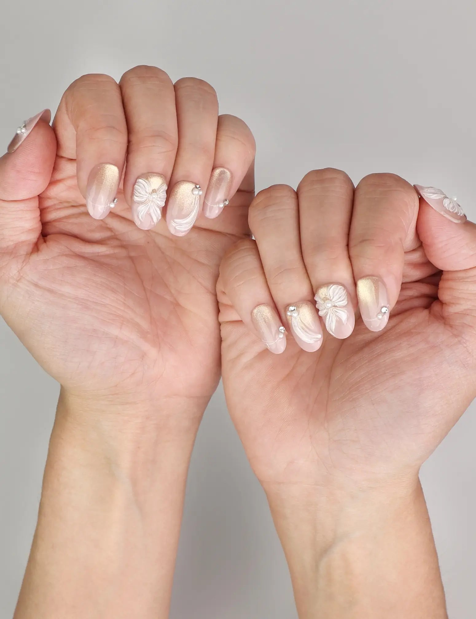 Naillover Pearl Bloom Bronze trendy nails styled on hand, featuring handmade bronze floral press on nails with delicate rhinestones.