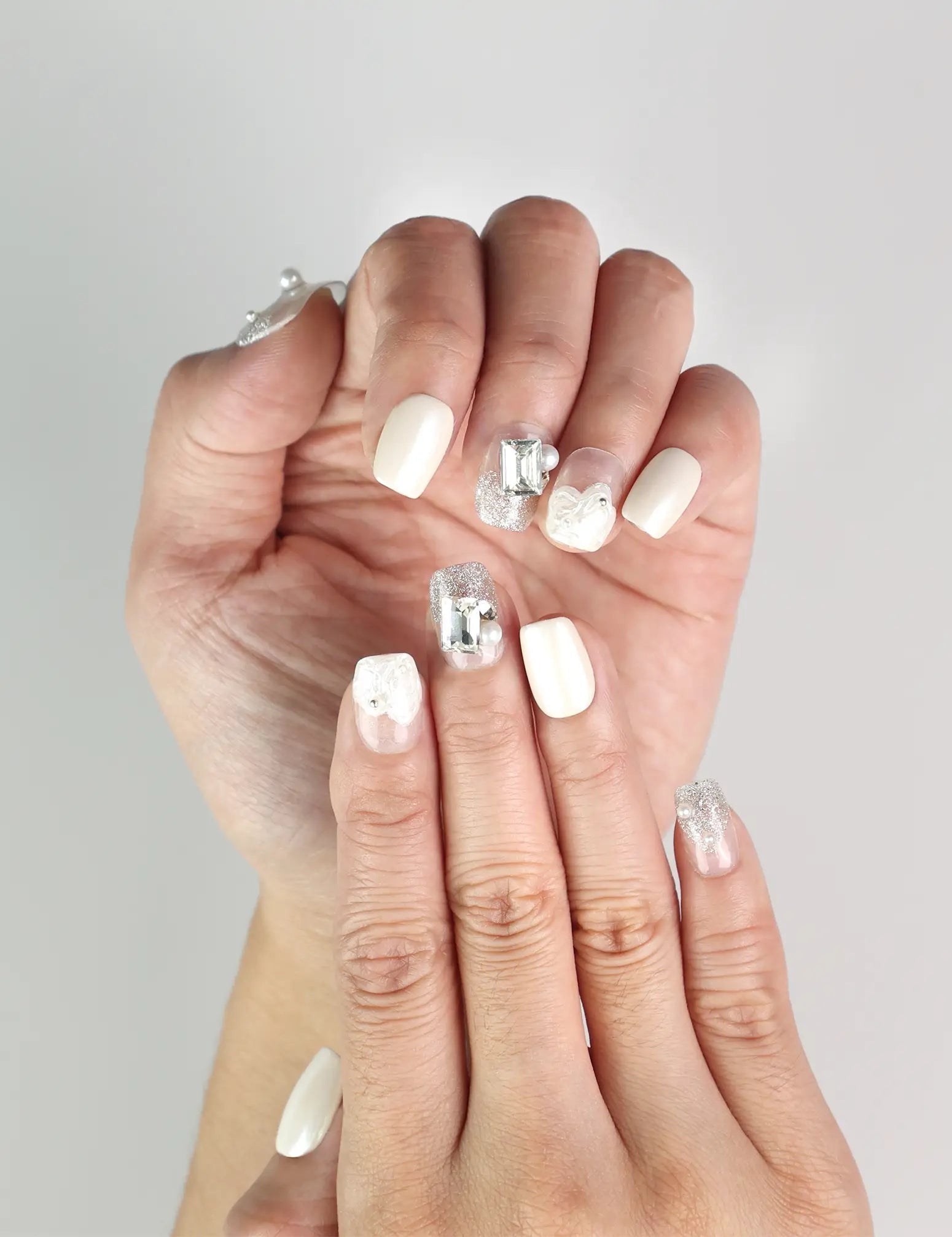 Close-up of Pearl Sparkle white press-on nails with pearl and gemstone accents, handmade Singapore nails by naillover