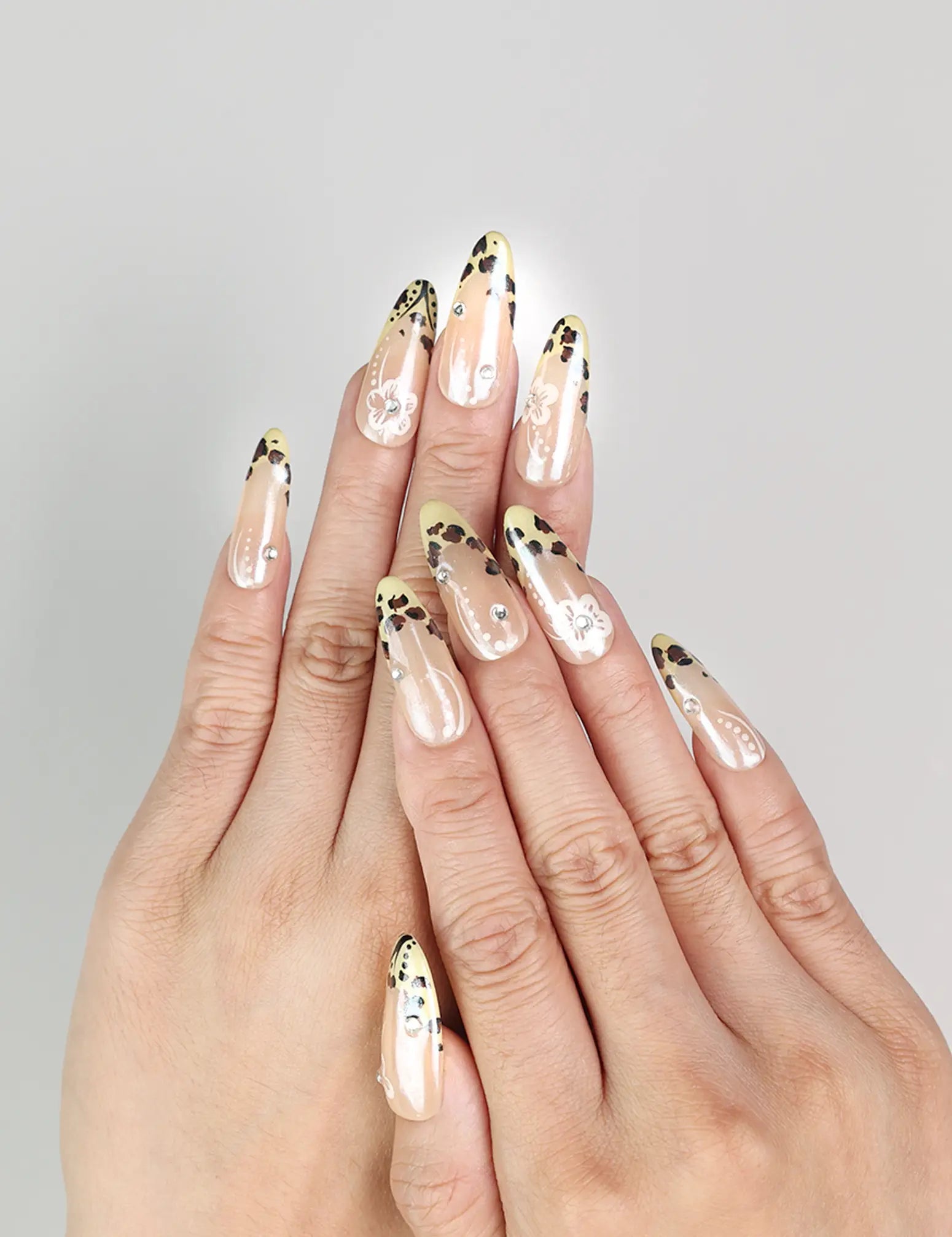 Model wearing Pearly Blossom Singapore press on nails with leopard print and floral designs, handmade by naillover