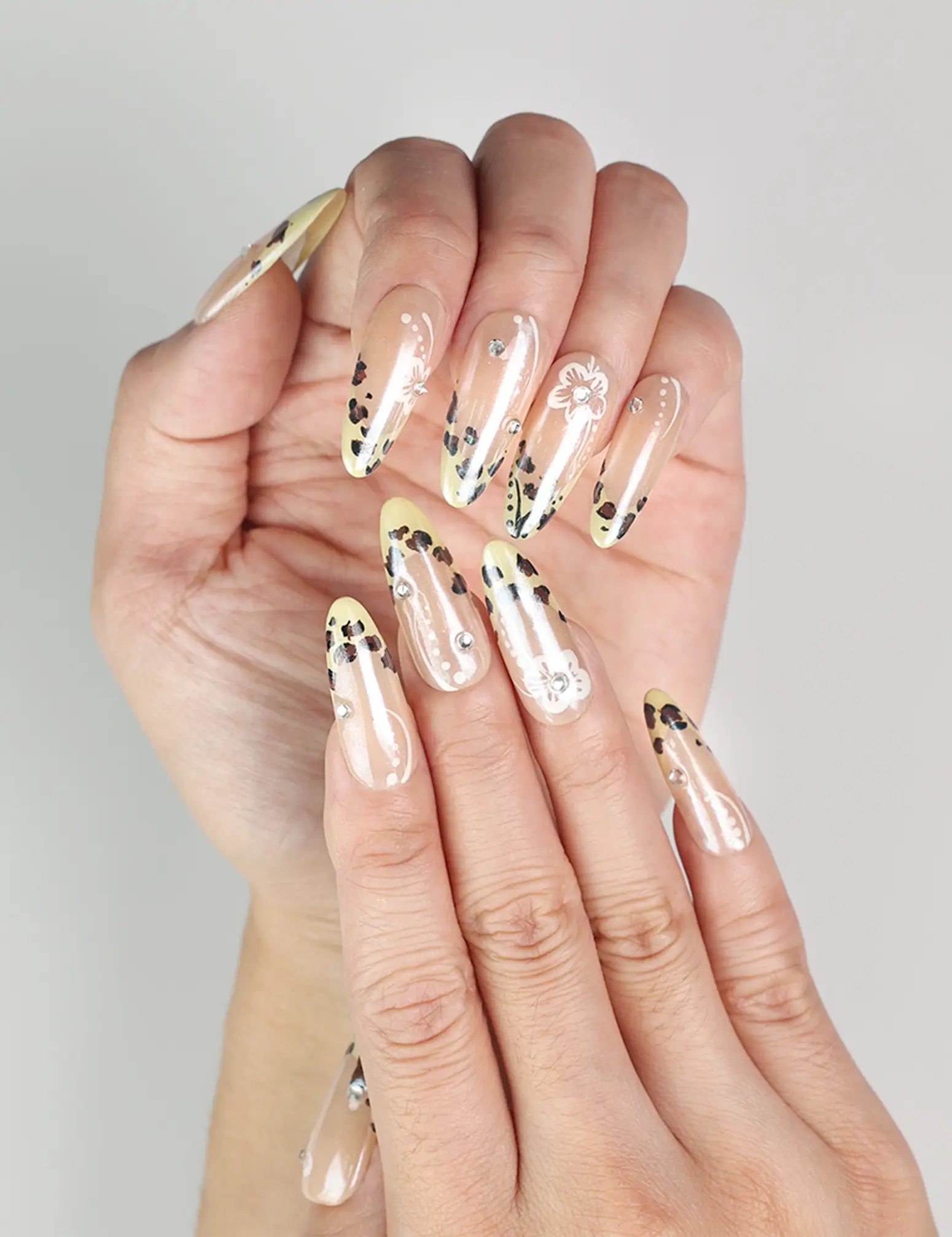Close-up of Pearly Blossom handmade Singapore press on nails featuring beige base with leopard and floral accents