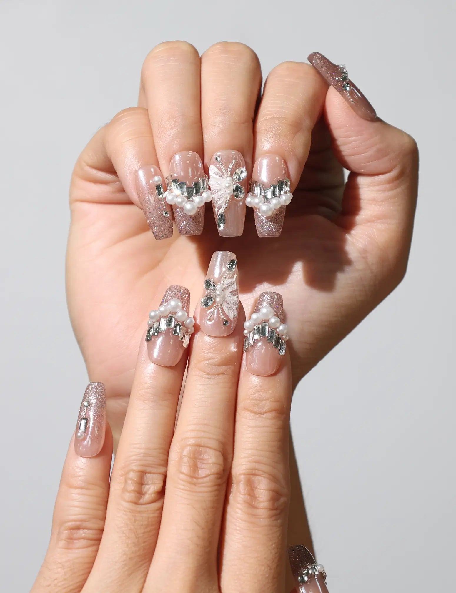Side view of Petal Crystal handmade Singapore press on nails, highlighting classic nude tone and crystal details