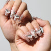 Petal Crystal Singapore press on nails worn on both hands, featuring elegant nude pink with floral and crystal accents