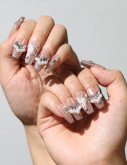 Petal Crystal Singapore press on nails worn on both hands, featuring elegant nude pink with floral and crystal accents
