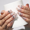 Petal Crystal handmade Singapore press on nails holding a coffee cup, showcasing delicate petals and shimmering crystals