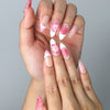 Close-up of Naillover’s handmade Singapore nails featuring sculpted floral designs in various shades of pink
