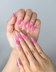 Close-up of Naillover’s handmade Singapore nails featuring gradient shimmer and glossy heart embellishments