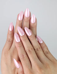 Hand with short almond-shaped press-on nails in glossy soft pink, perfect for daily wear