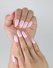 Close-up of pink glossy nails in short almond shape, showcasing a natural, understated manicure