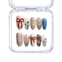 Handmade almond Singapore press on nails with red ribbons, rhinestones, and checkered designs by Naillover