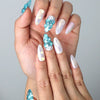 Close-up of Naillover’s handmade Singapore nails featuring pearlescent shell textures and golden sea star charms